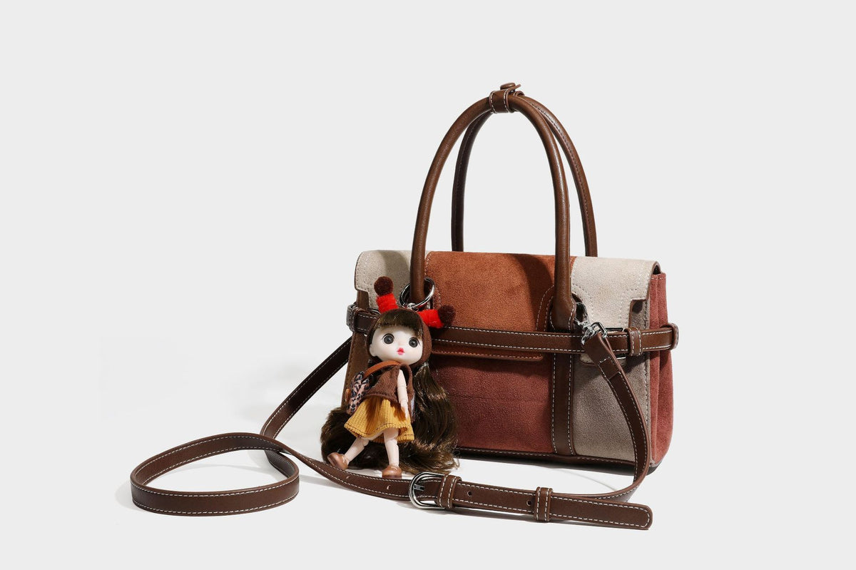 Structured color-block satchel bag in brown, rust, beige, and taupe suede-look panels with white topstitching, front buckle