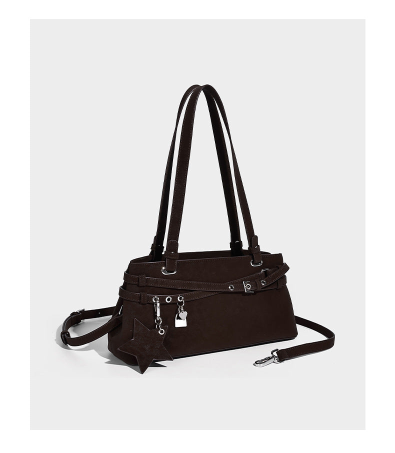 Structured trapezoid shoulder tote in dark brown matte suede-look finish with dual straps, wraparound belt bands