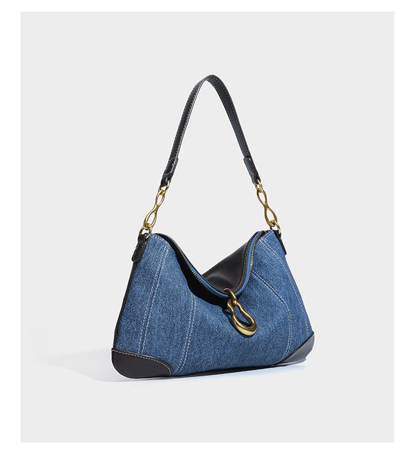 Slouchy denim shoulder bag with dark leather-look trim, gold-tone chain-link hardware, and top zipper closure, detail view 8