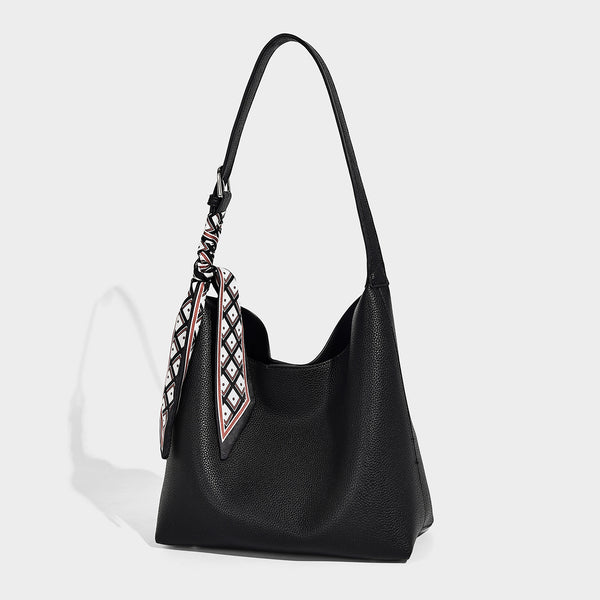 Soft slouchy hobo shoulder bag in pebbled matte finish with slim strap, silver-tone ring hardware, and knotted printed scarf