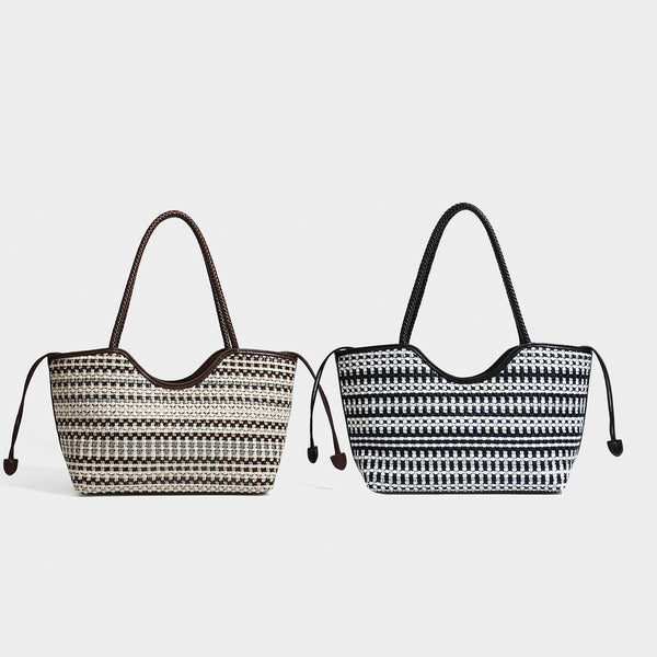 Large woven checker-pattern tote bag with dark braided shoulder straps, leather-look trim, and drawstring side ties, detail