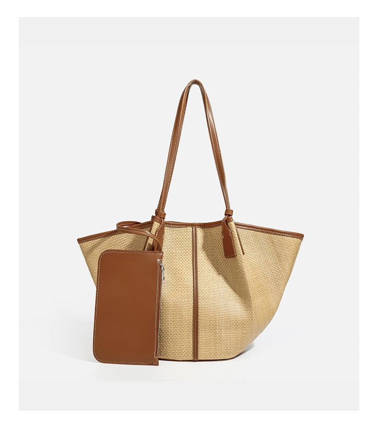 Tan woven tote bag with contrasting leather-look trim, long shoulder straps, and detachable rectangular zip pouch, detail
