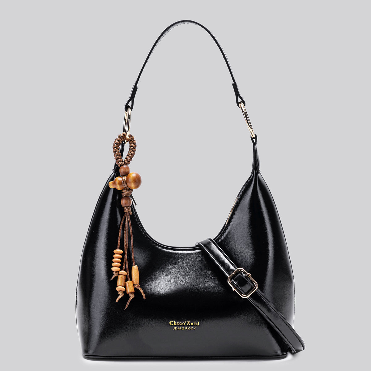 Glossy crescent hobo shoulder bag in deep burgundy with beaded wood tassel charm and gold-tone ring hardware, detail view 7
