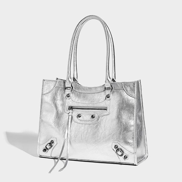 Large structured leather-look tote bag with front zip pocket, moto hardware accents, and long double shoulder straps, detail