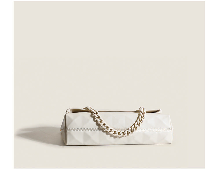 Cream white rectangular flap shoulder bag with geometric faceted surface and chunky tone-on-tone chain strap with gold-tone