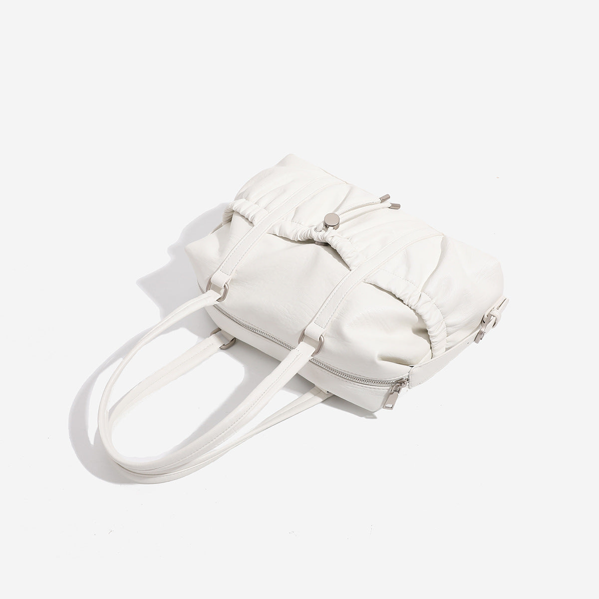 Ivory leather-look shoulder bag with ruched front panels, drawstring toggle, silver-tone hardware, and dual top handles
