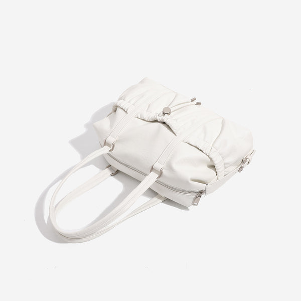 Ivory leather-look shoulder bag with ruched front panels, drawstring toggle, silver-tone hardware, and dual top handles