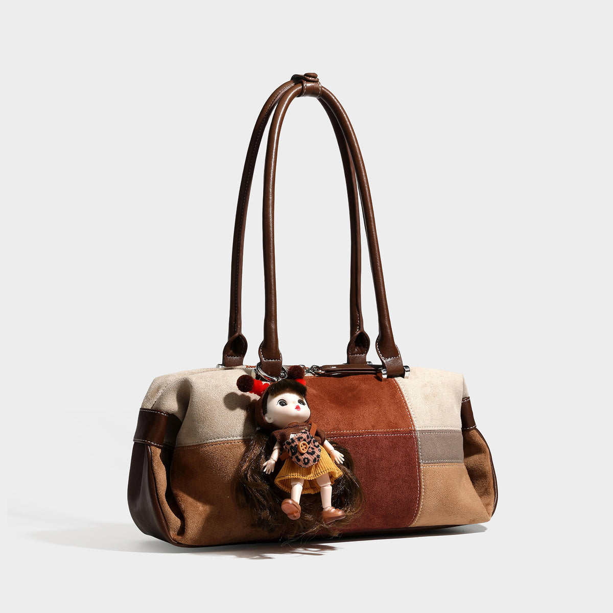 Patchwork suede-look barrel shoulder bag in brown, rust, tan, beige, and gray panels with double leather-look straps and