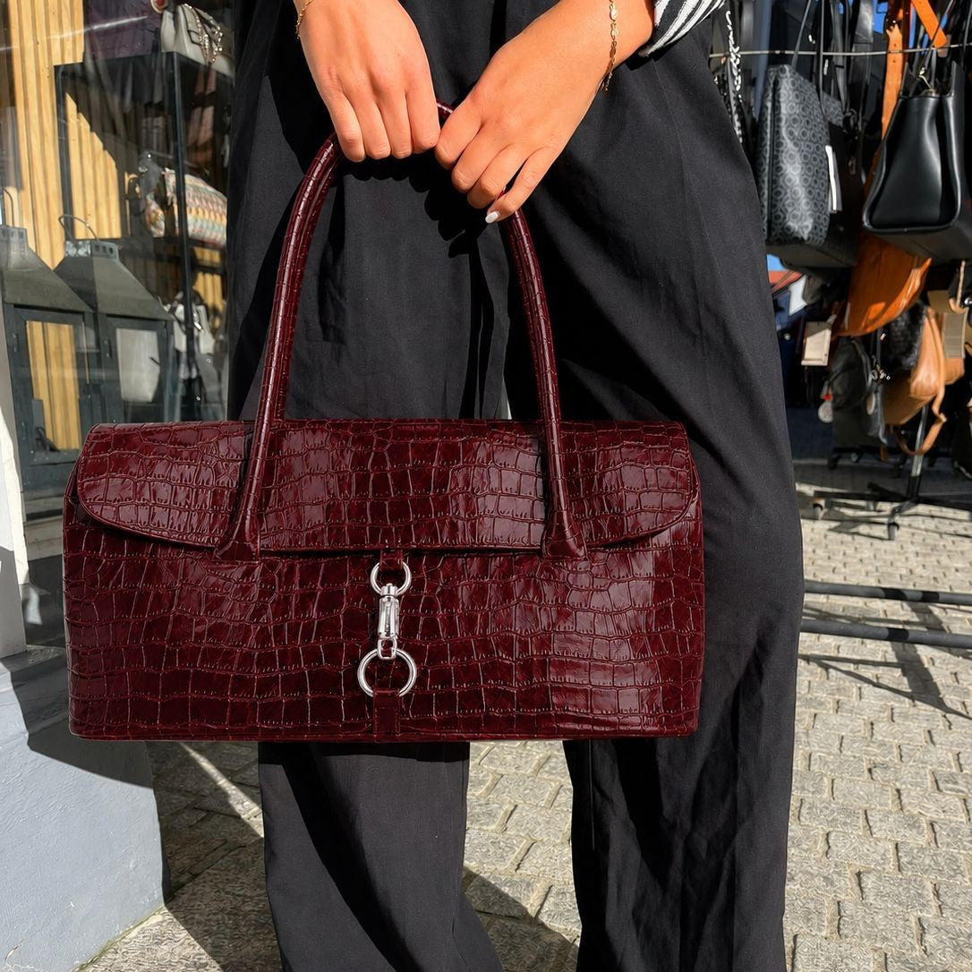 Glossy croc-embossed structured flap shoulder bag with silver ring-and-toggle hardware and twin top handles, detail view 2