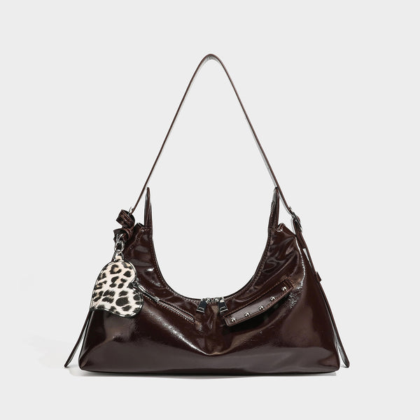 Glossy dark brown hobo shoulder bag with slim strap, front zip pocket, stud detail, and detachable leopard-print heart charm