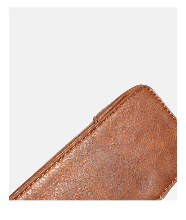 Structured trapezoid shoulder bag with pale textured flap, gold-tone triangular turn-lock closure, and long knotted cord