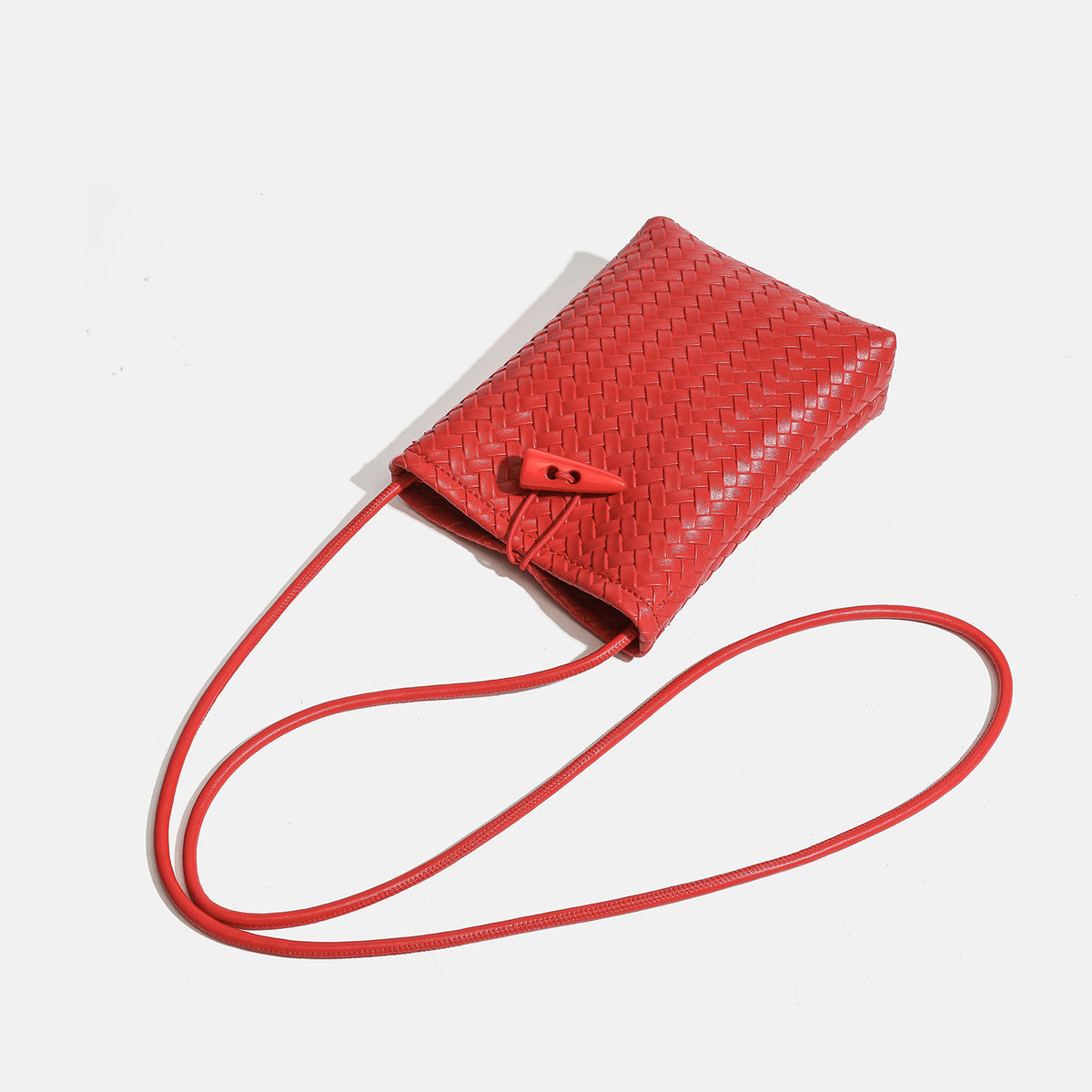Compact woven leather-look bucket crossbody pouch with toggle closure and long fixed strap, detail view 4