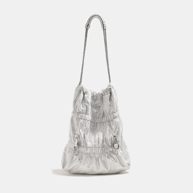 Slouchy lace-texture bucket bag with silver-tone chain strap, draped chain hardware, and shell charms, detail view 6