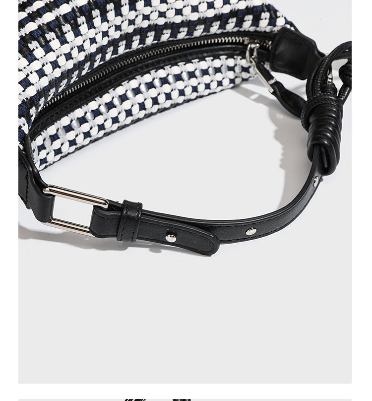 Small crescent shoulder bag in black-and-white woven textile with smooth black leather-look trim, zip-top closure, knotted