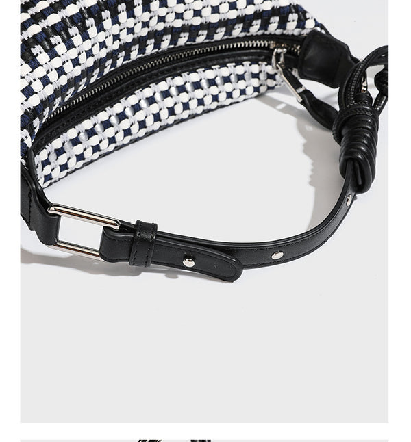 Small crescent shoulder bag in black-and-white woven textile with smooth black leather-look trim, zip-top closure, knotted