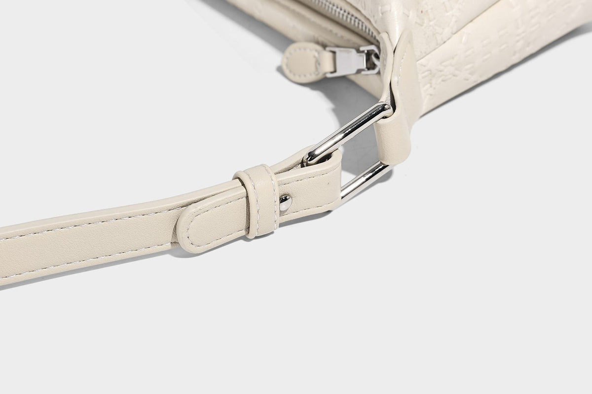 Small embossed half-moon shoulder bag with top zipper, detachable front pouch, and adjustable slim strap, detail view 23