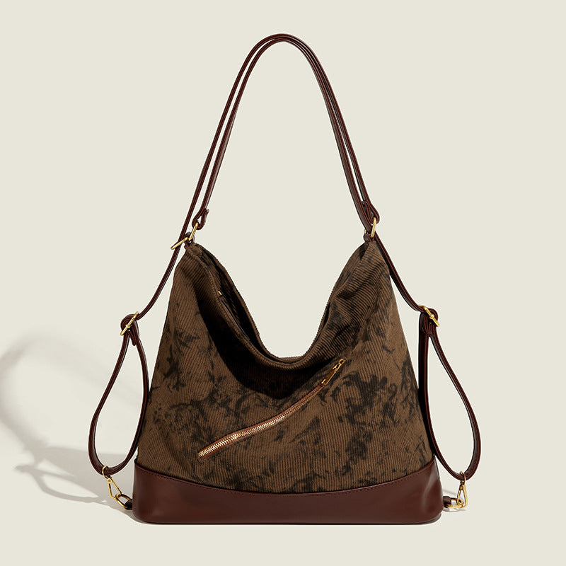 Large ink-wash printed corduroy hobo bag with dark brown leather-look base trim, diagonal front zip pocket, and gold-tone