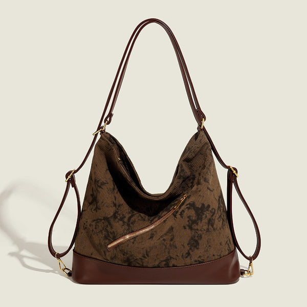 Large ink-wash printed corduroy hobo bag with dark brown leather-look base trim, diagonal front zip pocket, and gold-tone