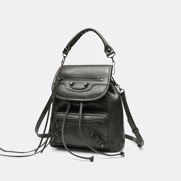 Small structured glossy leather-look convertible backpack handbag in black with flap closure, front zip pockets, metal stud