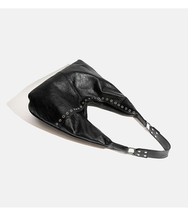 Large slouchy hobo shoulder bag with silver eyelet trim and glossy leather-look finish, detail view 9