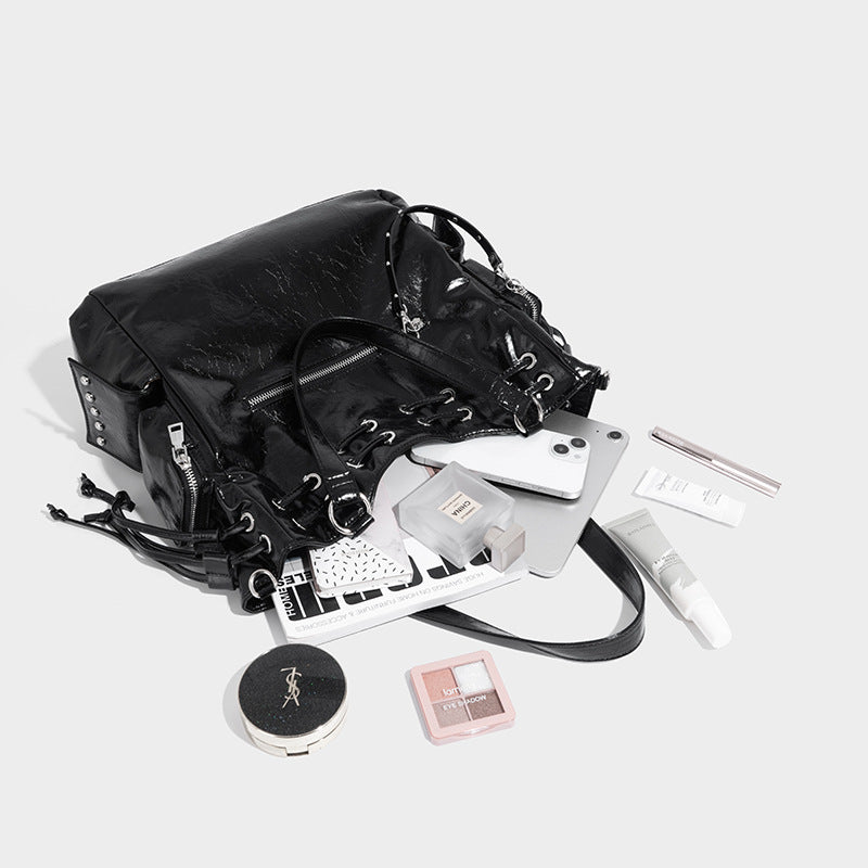 Glossy crinkled leather-look tote bag with silver grommet lace-up front detail, dual top handles, and detachable shoulder