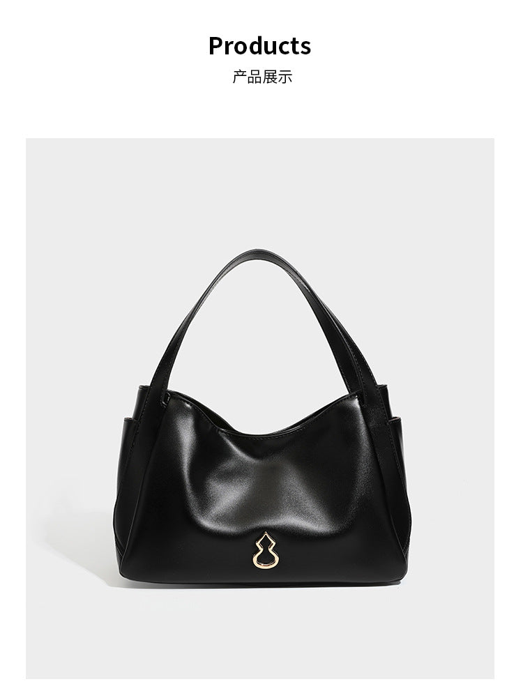 Structured glossy leather-look tote shoulder bag with dual top handles, detachable crossbody strap, side pockets, and, detail