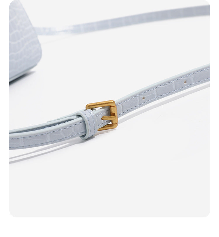 Small structured crocodile-embossed top-handle bag with gold-tone turn-lock closure and detachable shoulder strap, detail