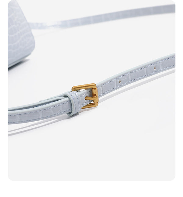 Small structured crocodile-embossed top-handle bag with gold-tone turn-lock closure and detachable shoulder strap, detail