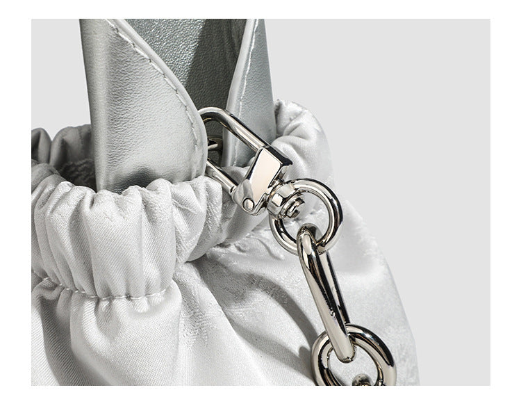 Small ruched satin-finish cloud bag with elasticized drawstring top, short top handle, and chunky silver-tone chain strap
