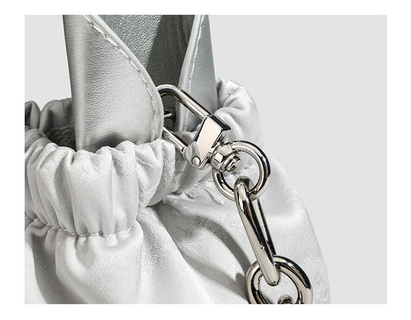 Small ruched satin-finish cloud bag with elasticized drawstring top, short top handle, and chunky silver-tone chain strap