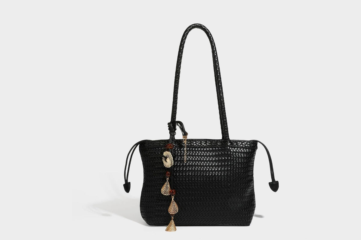 Structured woven leather-look tote bag in dark brown with long shoulder straps, side drawstring ties, and gold filigree