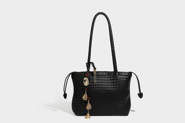 Structured woven leather-look tote bag in dark brown with long shoulder straps, side drawstring ties, and gold filigree
