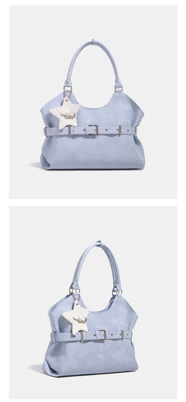 Large soft hobo shoulder bag with glossy textured finish, decorative belt buckle, star charm, and silver-tone hardware