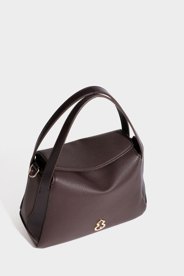 Structured pebbled leather-look shoulder bag with flap top, gold-tone emblem hardware, dual top handles, and detachable