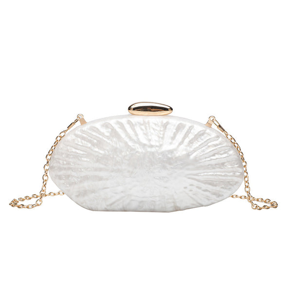 Oval pearl-finish shell clutch bag with gold-tone clasp and removable gold link chain strap, detail view 5