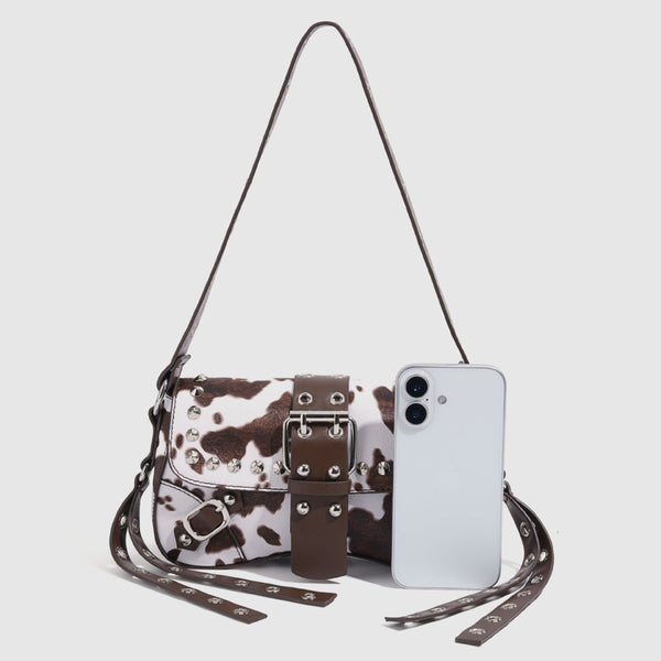 Mini square cow-print leather-look shoulder bag with metal stud hardware and dual carry straps, detail view 2