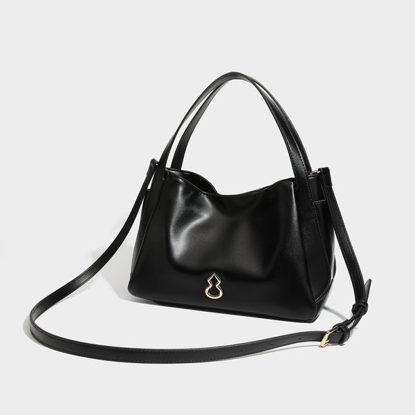 Structured glossy leather-look tote shoulder bag with dual top handles, detachable crossbody strap, side pockets, and, detail