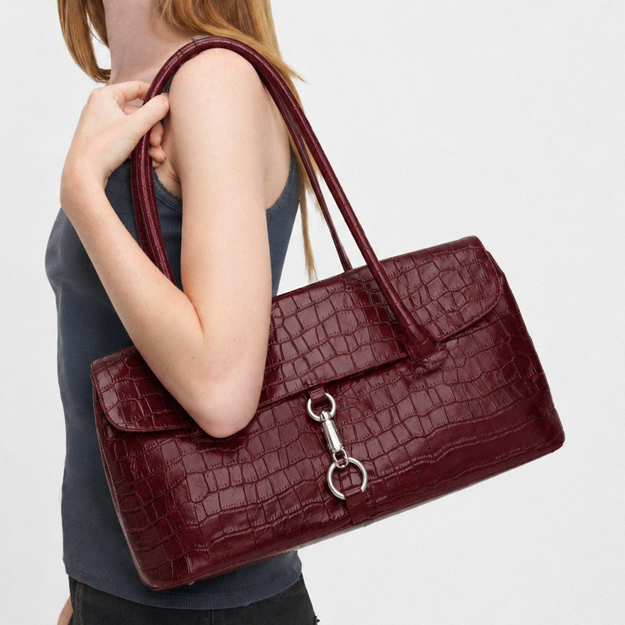 Glossy croc-embossed structured flap shoulder bag with silver ring-and-toggle hardware and twin top handles, front view