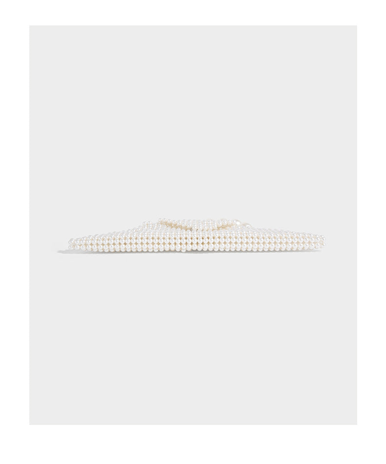 Small structured triangle clutch bag covered in glossy pearl beads with an arched pearl top handle and silver snap closure