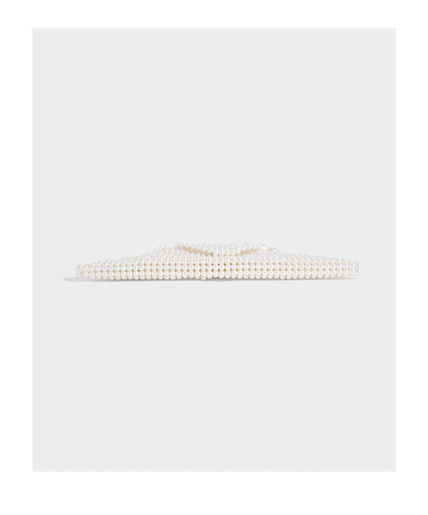 Small structured triangle clutch bag covered in glossy pearl beads with an arched pearl top handle and silver snap closure