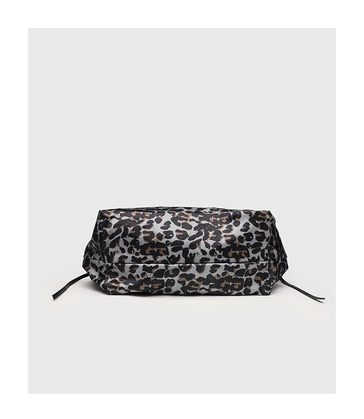 Large leopard-print slouchy tote shoulder bag in grey, black, and tan with gold-tone hardware and adjustable leather-look