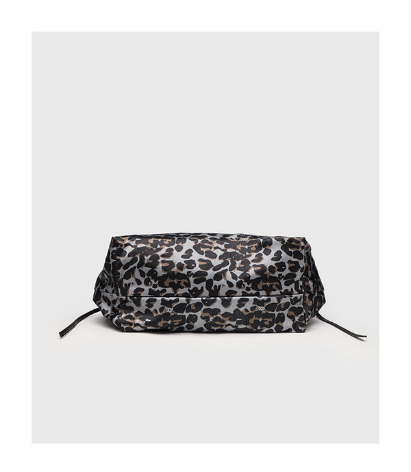 Large leopard-print slouchy tote shoulder bag in grey, black, and tan with gold-tone hardware and adjustable leather-look