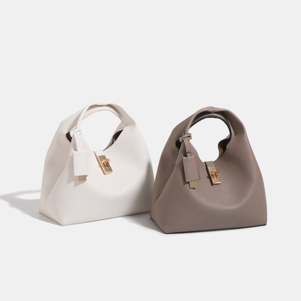Structured pebbled leather-look bucket tote with gold-tone turn-lock hardware and looped top handle, detail view 2