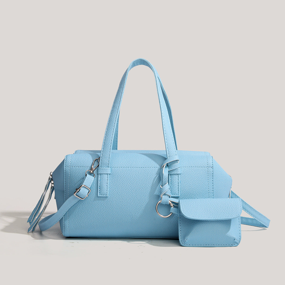 Light blue pebbled matte Boston tote bag with top handles, detachable shoulder strap, metal ring hardware, and matching mini