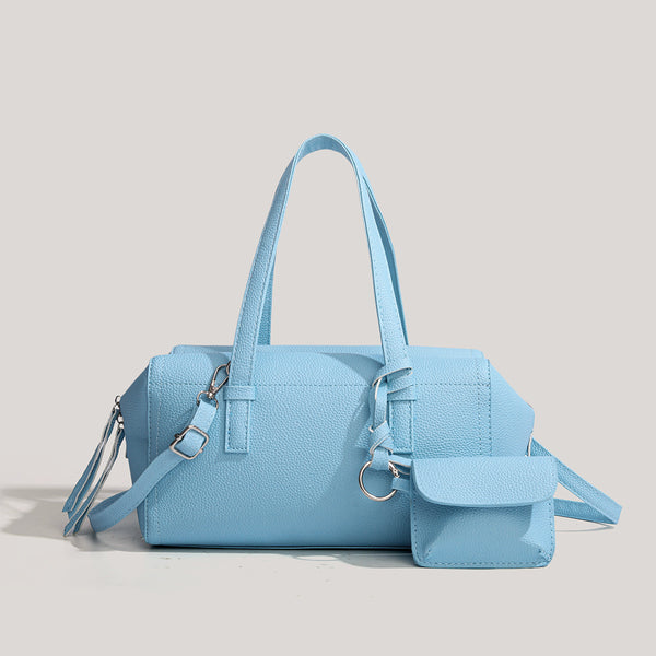 Light blue pebbled matte Boston tote bag with top handles, detachable shoulder strap, metal ring hardware, and matching mini