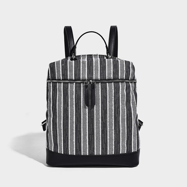 Small structured striped fabric backpack handbag with cream leather-look trim, top handle, and silver-tone hardware, detail