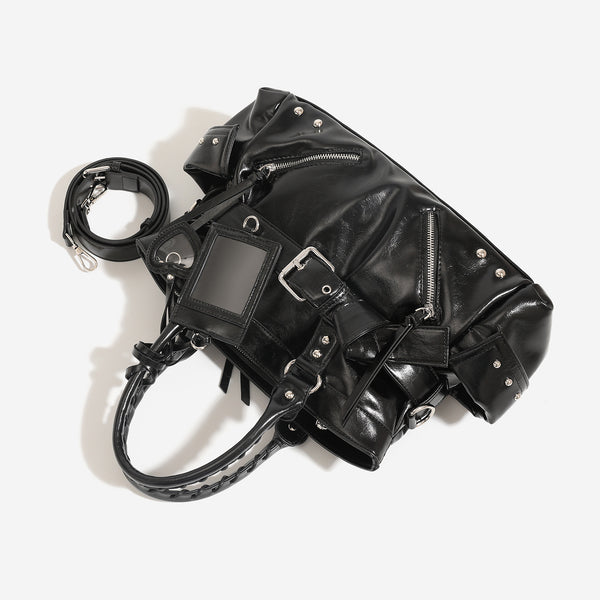 Black glossy leather-look structured tote bag with silver studs, buckle strap, exterior zip pockets, braided top handles