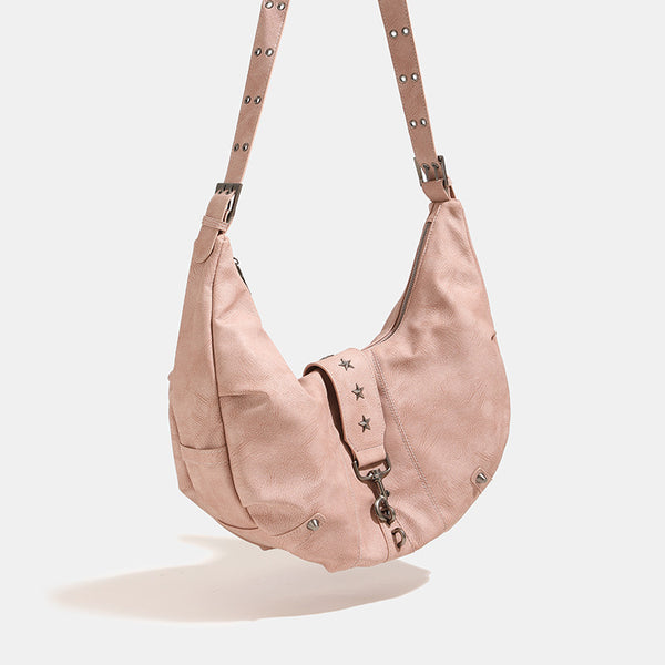 Crescent hobo shoulder bag in matte leather-look finish with star stud front panel, antique-silver hook hardware, and, detail