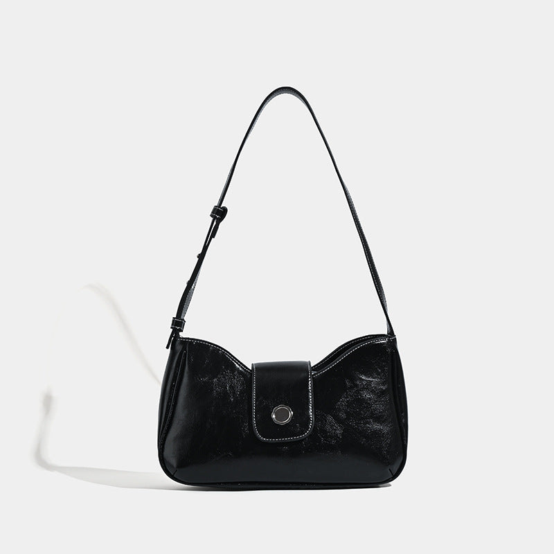 Compact glossy leather-look shoulder bag with round metal snap closure and contrast stitching, detail view 6