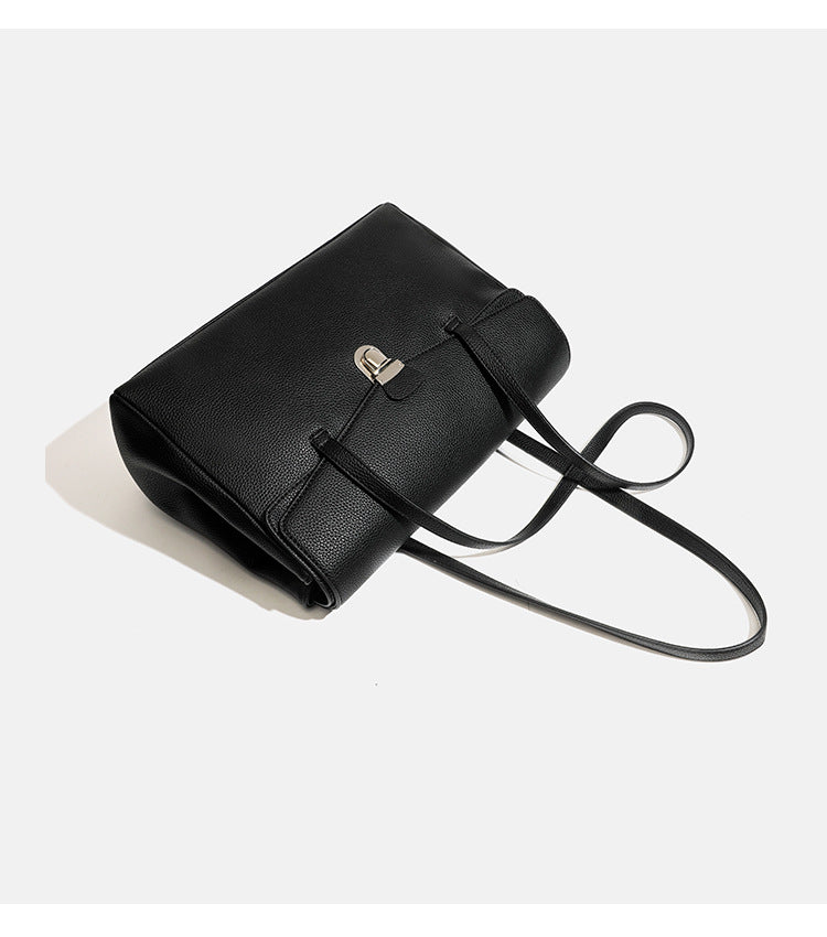 Structured black pebbled-finish flap tote bag with silver turn-lock clasp and long double shoulder straps, detail view 10
